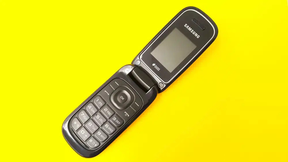 samsung old flip phone, yellow background